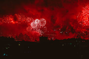 Breathtaking fireworks illuminate the night sky over the Sydney Opera House during New Year's Eve celebrations. HD wallpaper