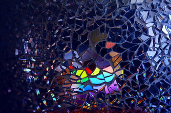 A colorful rainbow reflection through broken glass, creating an artistic and abstract effect. HD wallpaper