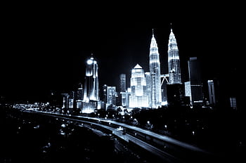 A breathtaking black and white view of Kuala Lumpur skyline featuring illuminated skyscrapers at night. HD wallpaper