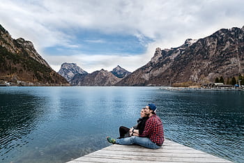 Couple enjoying a scenic view of the lake and mountains in Ebensee, Austria. HD wallpaper