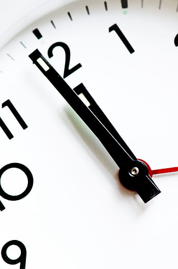 Detailed view of a black and white analog clock face with hands pointing near twelve. HD phone wallpaper
