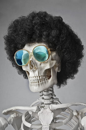 A skeleton wearing an afro wig and sunglasses, set against a gray background. HD phone wallpaper