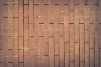 A vintage red brick wall texture serves as a classic background with rich earthy tones. HD wallpaper