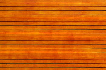 Close-up of a vibrant orange wooden wall texture, ideal for backgrounds. HD wallpaper