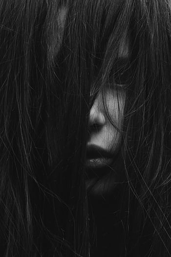 A dark and mysterious portrait of a girl with long hair obscuring her face in Kyiv, Ukraine. HD phone wallpaper