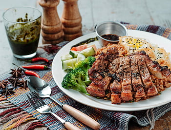 Delicious grilled pork with broccoli, cucumber, and egg served on rice for a tasty meal. HD wallpaper