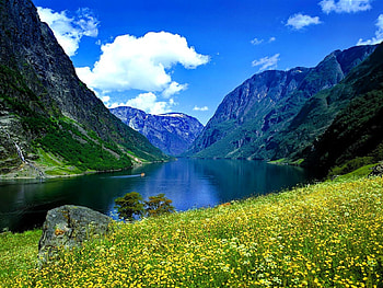 Blue river and mountain, blue, river, nice, shore, reflection, bright, slopes, meadow, beautiful, high, rocks, stones, mountain, summer, view, clouds, nature, sky, flowers, riverbank, clear, lovely HD wallpaper