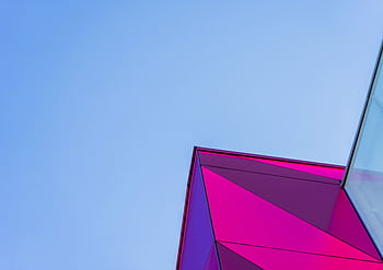Vibrant modern architectural structure with geometric designs against a clear blue sky. HD wallpaper