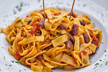 Close-up of delicious Italian pasta dish with kidney beans and rich sauce. HD wallpaper