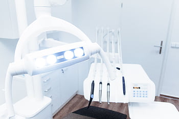 Bright and clean modern dental clinic room with advanced dental equipment. HD wallpaper