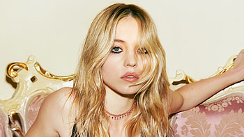 Actress Sydney Sweeney Is Sitting On Chair In Half White Color Wall Background Girls HD wallpaper