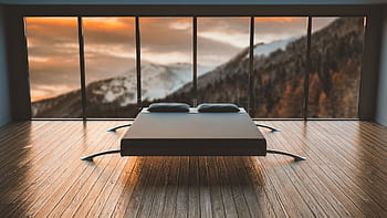 Minimalist bedroom with large windows offering a breathtaking mountain view during sunset. HD wallpaper