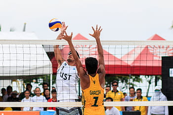 Beach volleyball action shot of two players competing at a tournament in Pasay, Philippines. HD wallpaper