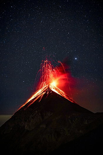 A breathtaking view of a volcano eruption with glowing lava against a starry night sky. HD phone wallpaper