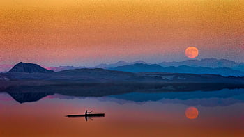 Serene kayak journey on reflective water with stunning sunset and moonrise over mountainous landscape. HD wallpaper