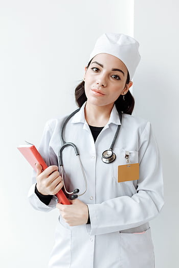 A serious female healthcare professional in uniform with a stethoscope and book. HD phone wallpaper