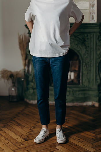 Minimalist fashion shot with white t-shirt, blue jeans, and sneakers indoors. HD phone wallpaper