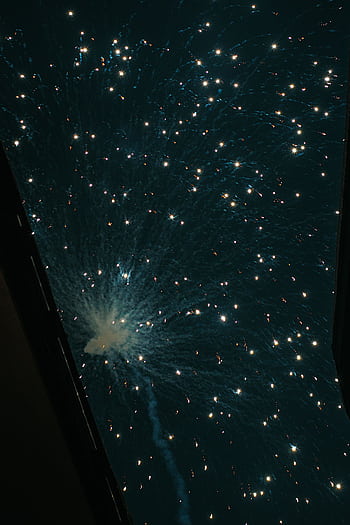 Captivating display of fireworks lighting up the night sky, creating a mesmerizing spectacle. HD phone wallpaper