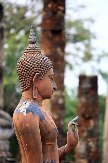 Side view of a weathered Buddha sculpture in a historic Asian temple setting. HD phone wallpaper