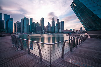 Breathtaking view of Singapore's modern skyline reflecting on the water at twilight. HD wallpaper