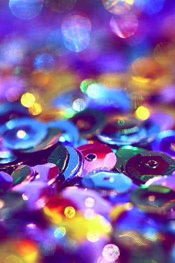 Vibrant macro shot of colorful sequins with a sparkling bokeh effect. HD phone wallpaper