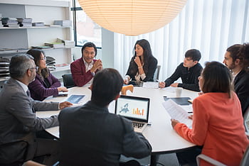 A diverse group of professionals collaborating in a modern conference room. HD wallpaper