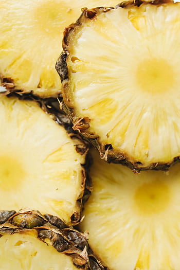 Vibrant close-up of fresh pineapple slices displaying juicy texture. Perfect for tropical themes and healthy food concepts. HD phone wallpaper