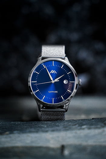 Close-up shot of an elegant wristwatch with a blue sapphire dial and metal mesh strap. HD phone wallpaper