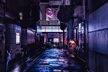 A vivid night scene capturing a wet alley in Tokyo with neon lights and urban architecture. HD wallpaper