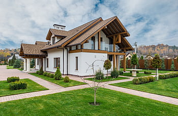 Contemporary countryside home featuring a manicured lawn and elegant design. HD wallpaper