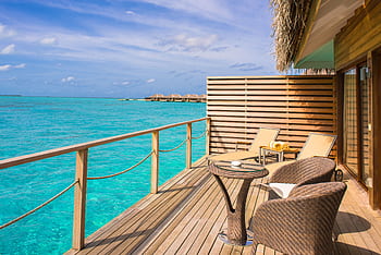Peaceful overwater bungalow with ocean view, perfect for a tropical getaway. HD wallpaper