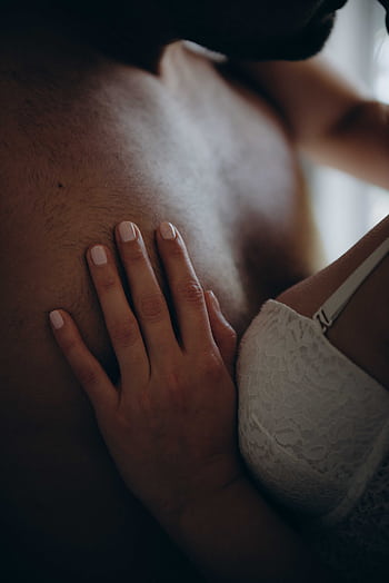 A sensual close-up shot of a couple's intimate embrace, highlighting skin contact. HD phone wallpaper