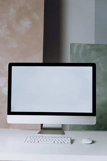 A sleek computer setup in a minimalist office space with a clean design. HD phone wallpaper