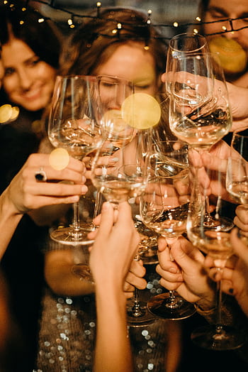 Group of people toasting with champagne glasses during a festive New Year's Eve party. HD phone wallpaper