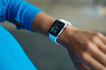 Focus on a smartwatch worn on an adult's wrist, showcasing its digital display. HD wallpaper