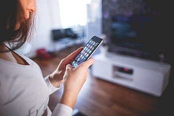 Woman browsing smart indoors, highlighting modern technology and communication in a cozy home setting. HD wallpaper