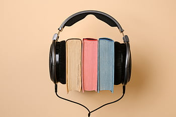 Stylish conceptual of heads and books on a beige background, symbolizing audiobooks. HD wallpaper