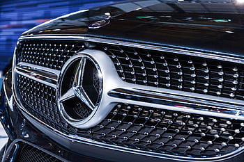 Detailed view of the iconic Mercedes Benz emblem showcasing luxury and design excellence. HD wallpaper