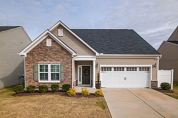 A welcoming suburban family house with a modern facade, perfect for residential living. HD wallpaper