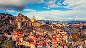 Georgia cityscape, Architectural beauty, Cloud-dotted sky, Urban charm HD wallpaper