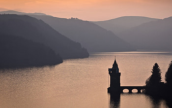 The Tower On The Lake, hills, beautiful, sunrise, lake, pretty, tower, bridge, castle, mountains, water, silhouette, sunset HD wallpaper