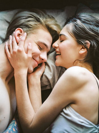 A joyful and intimate moment of a young couple embracing and smiling together. HD phone wallpaper