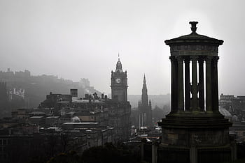 A scenic view of Edinburgh's iconic Calton Hill under grey skies, featuring historic monuments. HD wallpaper