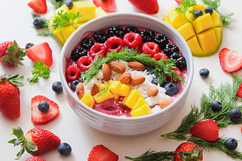 Colorful smoothie bowl with fresh fruits and almonds, perfect for a healthy breakfast. HD wallpaper