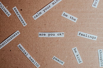 Cut-out words promoting mental health awareness on cardboard background. HD wallpaper