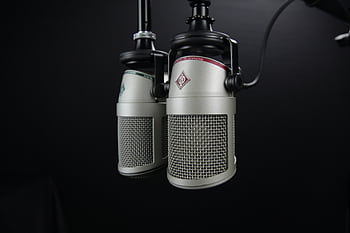 Close-up of two professional micros in a recording studio, ideal for podcasts and music production. HD wallpaper