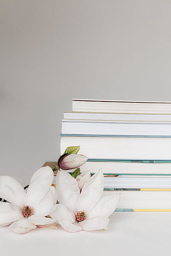 Aesthetic arrangement of white magnolia flowers and books. Perfect for minimalist decor. HD phone wallpaper
