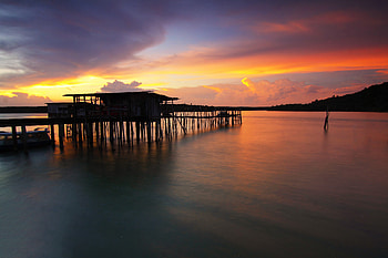 Silhouette Wooden Houses Above Sea Sunet, nature, sea, sunset, evening, sunset HD wallpaper