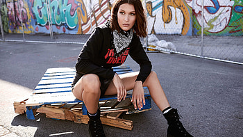 Bella Hadid Is Sitting On Wood Board Wearing Black Dress In Graffiti Wall Background Girls HD wallpaper