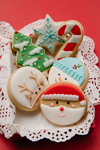 Colorful Christmas cookies with festive icing on a red background. HD phone wallpaper